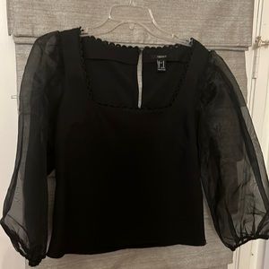 Black top with chiffon arms . Worn once